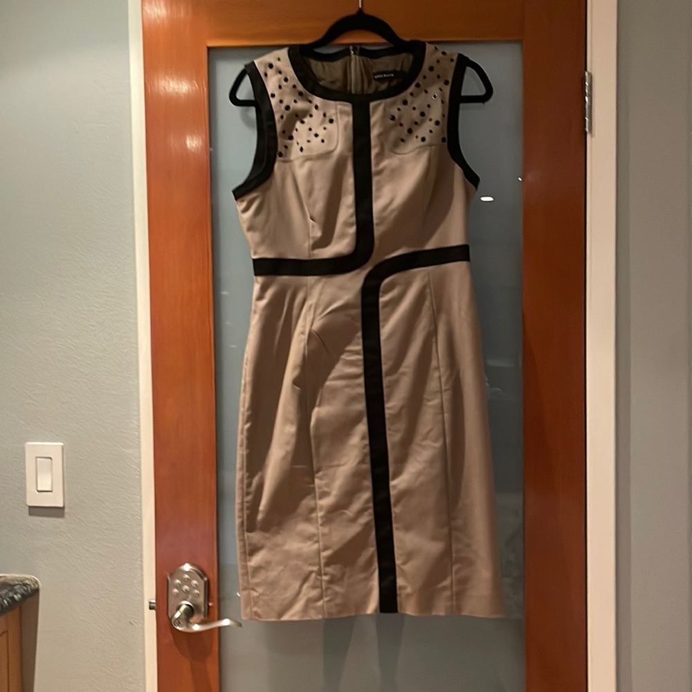 Karen Millen dress. Size 10 USA.Beige color with black trim. Detail metal accent